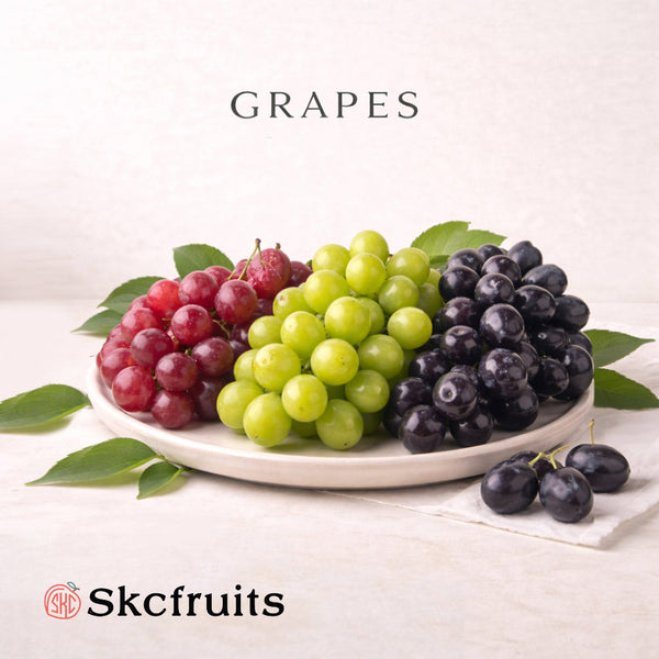 Skcfruits seedless grapes of red, green and black table grapes on neutral background