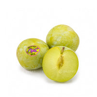 Three USA Emerald Beaut Plums (PLU #4435) with one cut open showing juicy golden-yellow flesh on a pure white background.