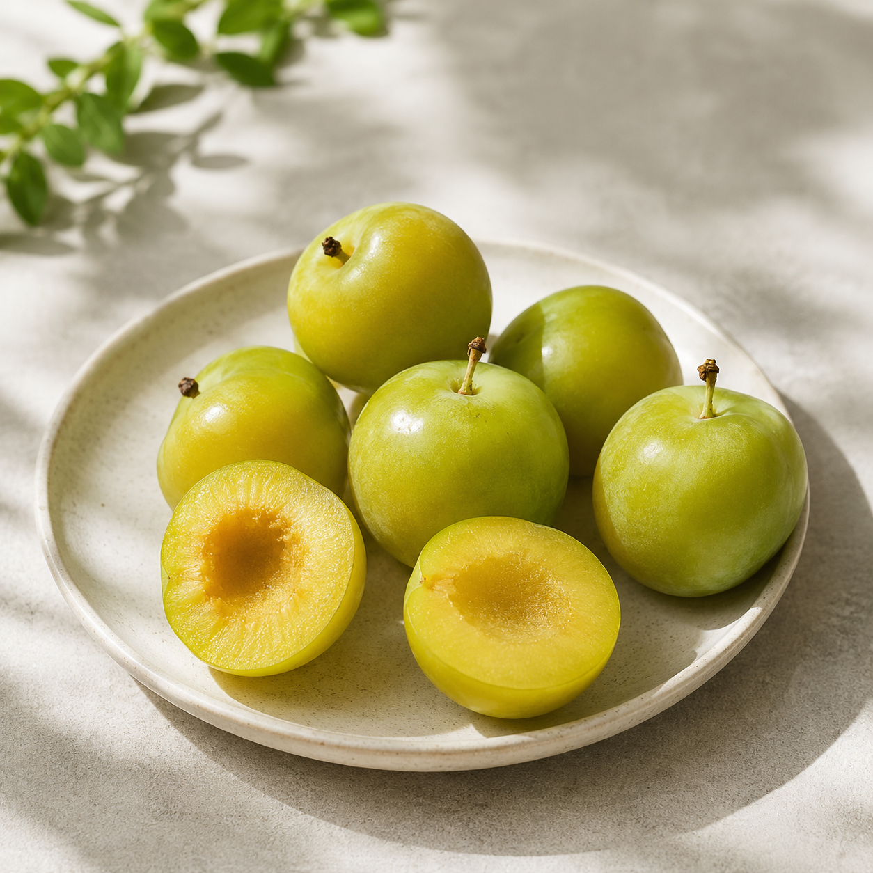 Fresh imported USA Emerald Beaut Plums (PLU #4435) arranged for an e-commerce product image with crisp green skin and subtle shadow on a white background.