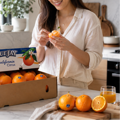 Person enjoying fresh Blue Jay navel orange segments in Singapore