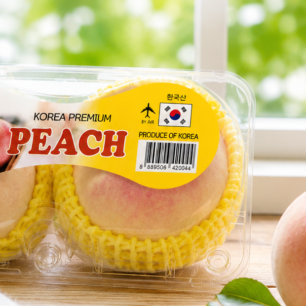 Two cartons of KOREA PREMIUM PEACH from South Korea are shown in a split before-and-after style composition. The top half shows the packaged peaches in a clear plastic tray with yellow foam sleeves and a yellow label.