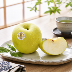 Cut Japanese Orin apple showing cream-coloured juicy flesh