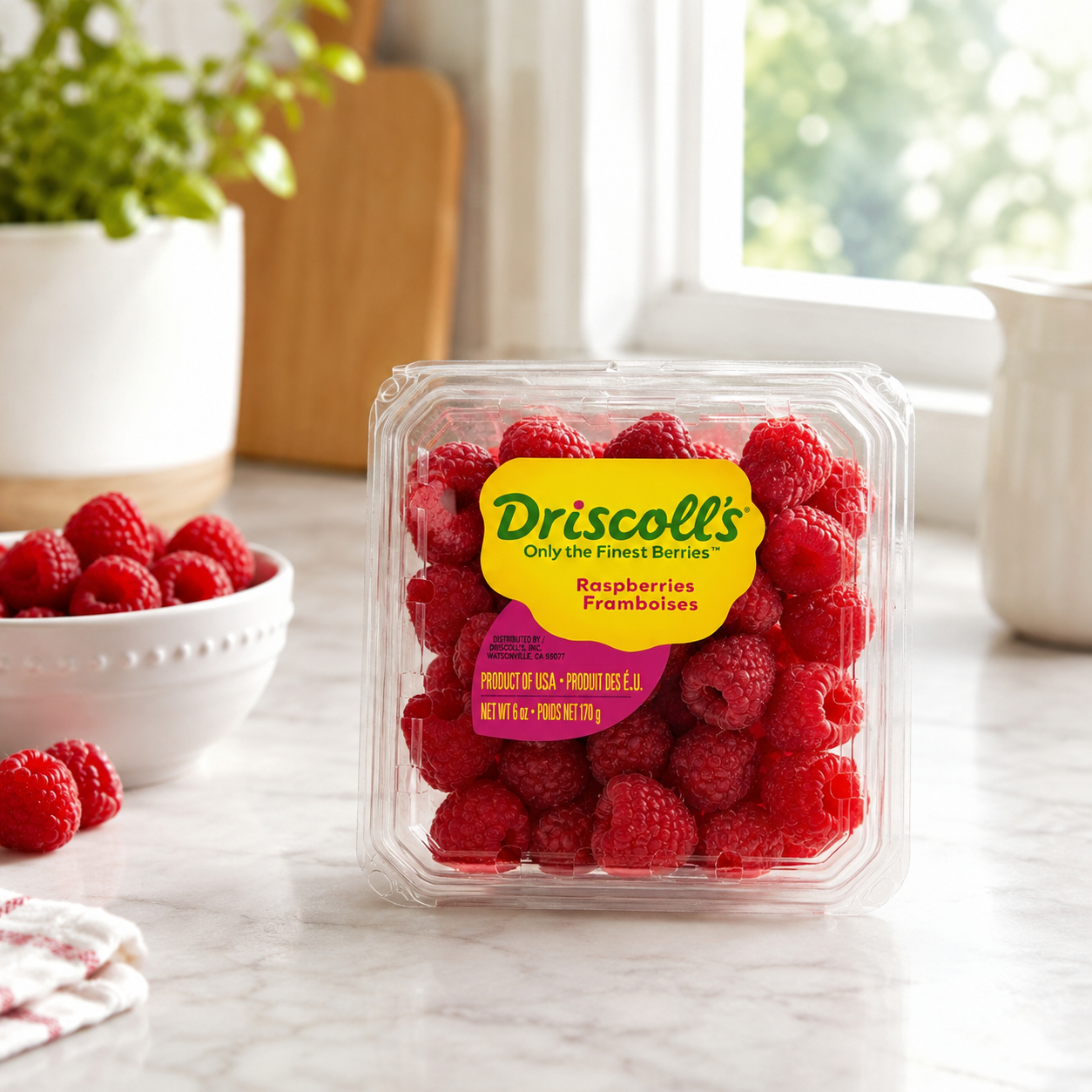 Packaged raspberries with Driscoll's label on a kitchen counter