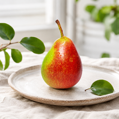 Red pear shaped fruit with sweet smooth pear texture