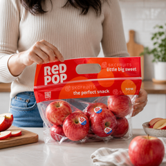 Person enjoying fresh Red Pop apple slices in Singapore