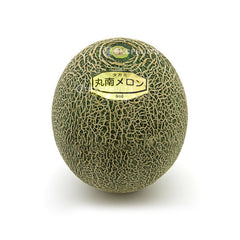 Cut open Takami melon showing juicy green muskmelon flesh