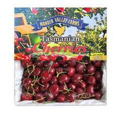 A package of Wandin Valley Farms Tasmanian Cherries, showing the cherries in a clear plastic container with a label indicating 2kg weight and the brand name.