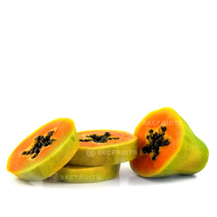 Cut open Hawaiian Papaya showing orange-red flesh and black seeds