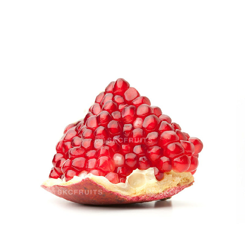 Fresh Spanish pomegranate fruit with juicy red seeds