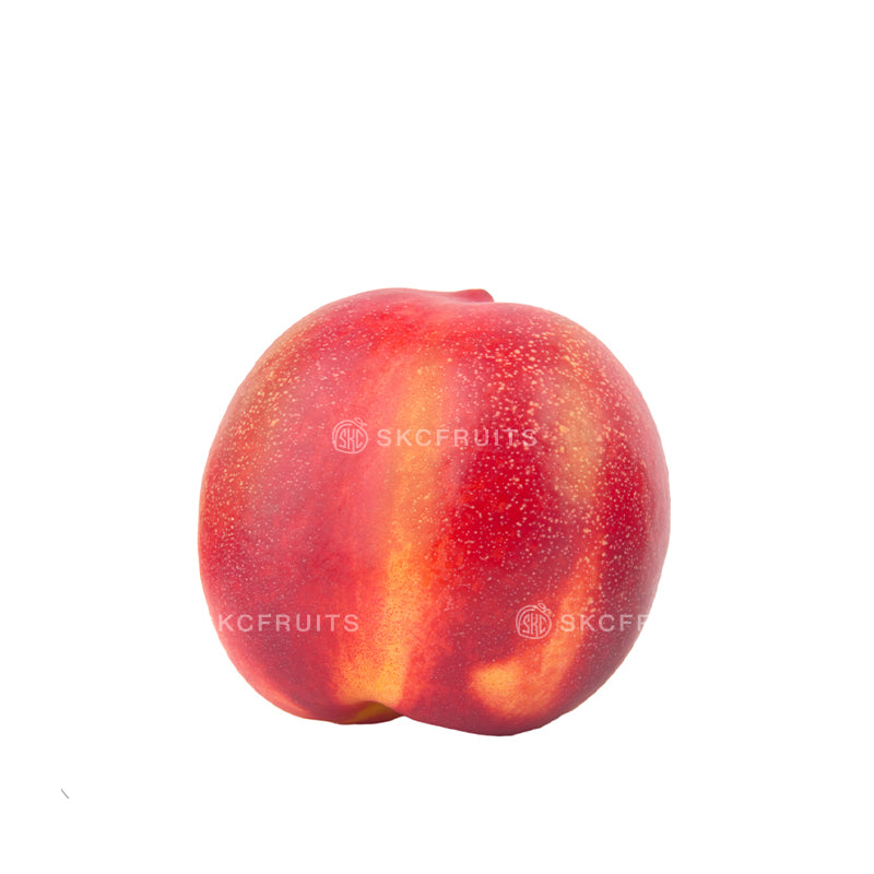 Yellow peach cut open showing golden-yellow juicy flesh